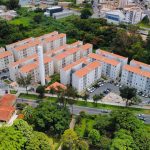 Vista aérea de um conjunto de prédios residenciais cercado por áreas verdes.